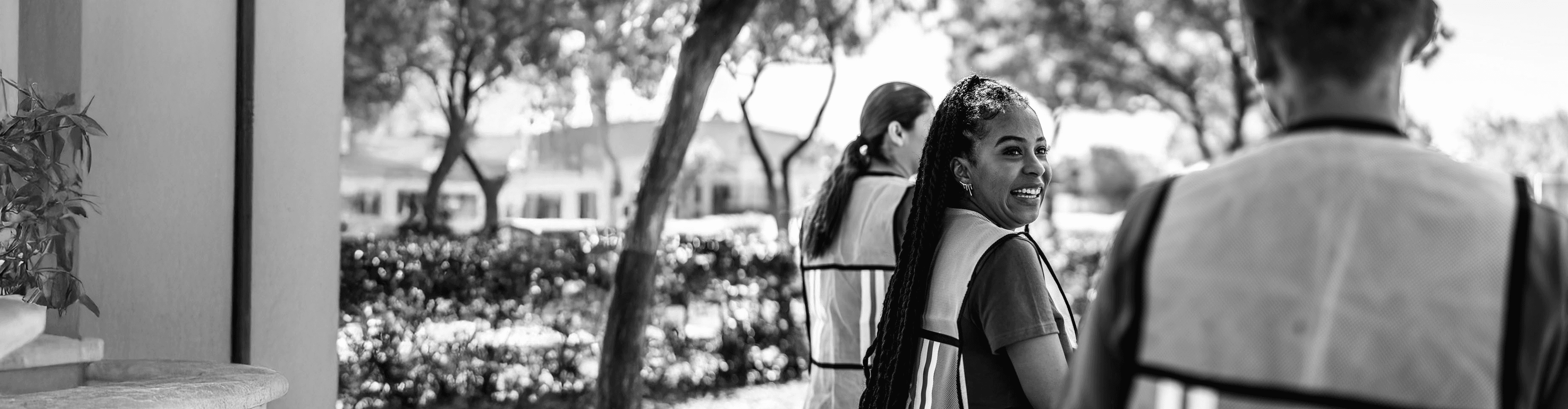 Woman smiling as she looks back at a fellow volunteer